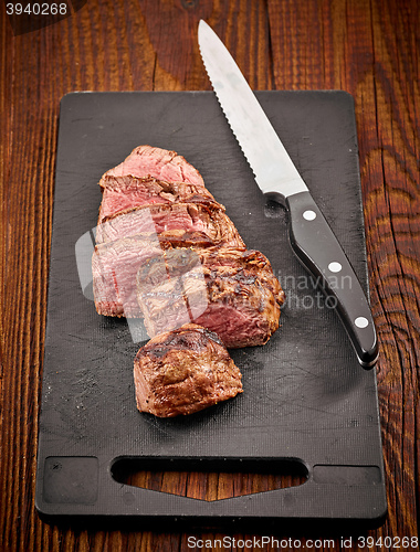 Image of grilled sliced beef steak and knife