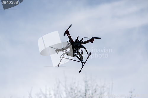 Image of flying drone with camera on the sky