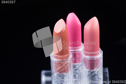 Image of bright lipsticks on a black background