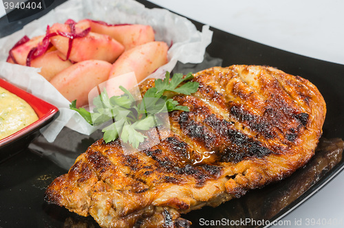 Image of plate of grilled meat with fries