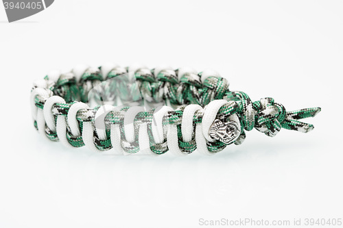 Image of green braided bracelet on white background