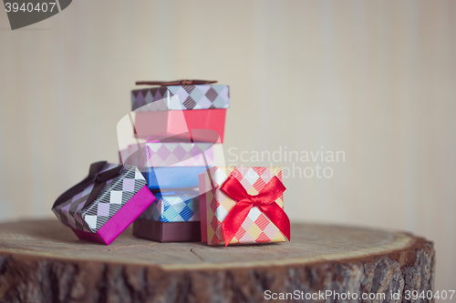 Image of Gift box with red bow on wood background