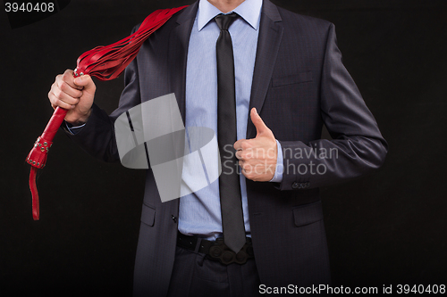 Image of man in business suit with chained hands. handcuffs for sex games