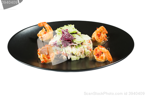 Image of perfect dish with shrimps on a black plate. seafood. Isolated  white background