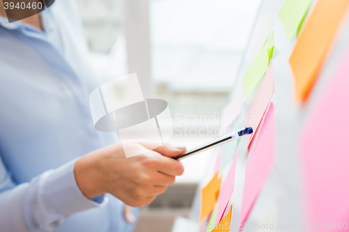 Image of close up of hand pointing to sticker on flip chart