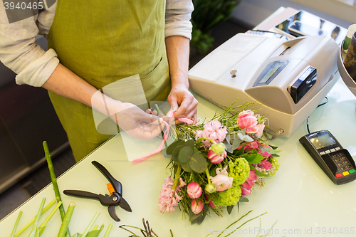 Image of close up of florist man with bunch at flower shop