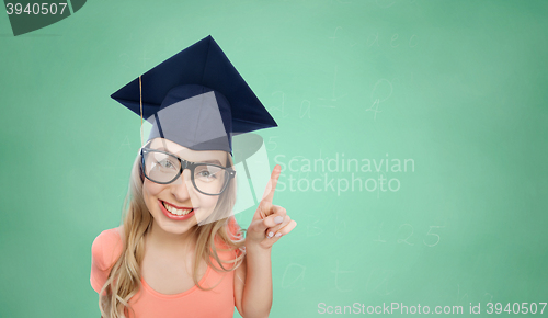 Image of smiling young student woman in mortarboard