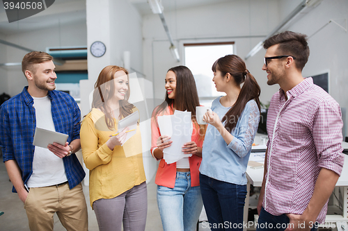 Image of creative team on coffee break talking at office