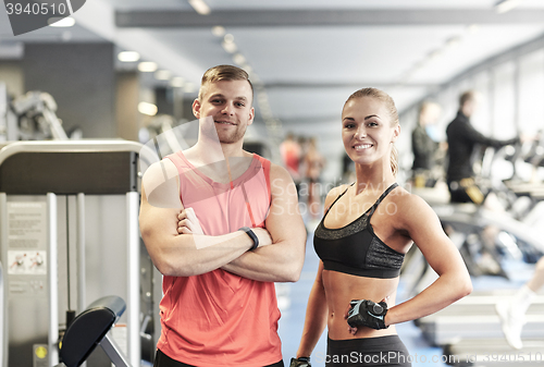 Image of smiling man and woman in gym