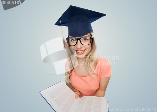 Image of student woman in mortarboard with encyclopedia