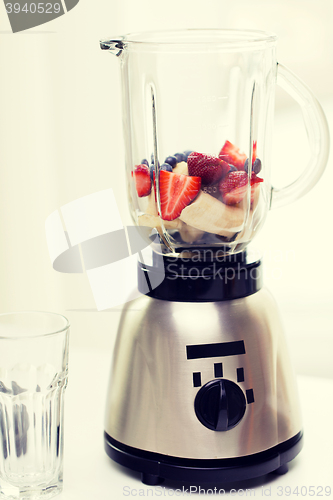 Image of close up of blender shaker with fruits and berries