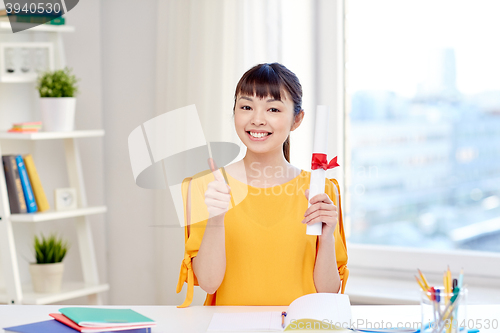 Image of happy asian woman student with diploma at home