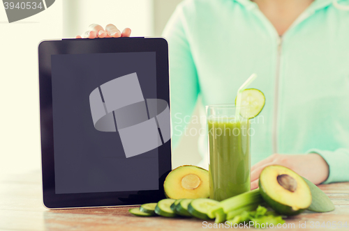 Image of close up of woman with tablet pc and vegetables