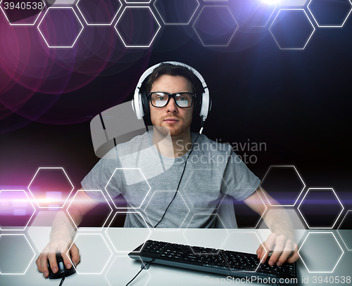 Image of man in headset computer over hexagons projection