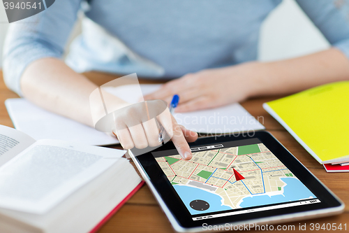 Image of close up of woman with navigator map on tablet pc