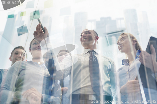 Image of smiling business people with marker and stickers