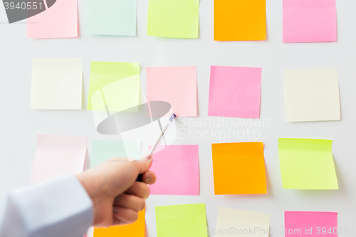 Image of close up of hand pointing to sticker on flip chart