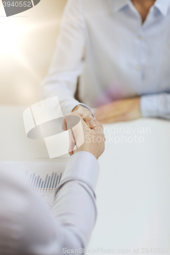 Image of businesswoman and businessman shaking hands