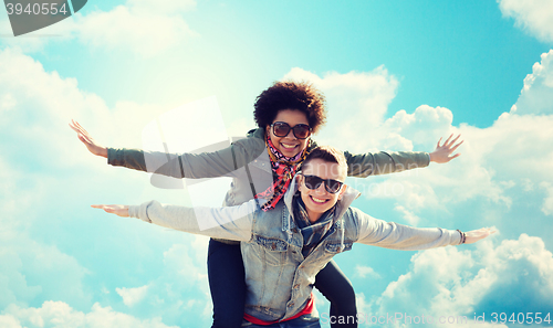 Image of happy teenage couple in shades having fun outdoors