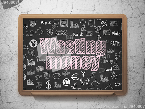Image of Banking concept: Wasting Money on School board background