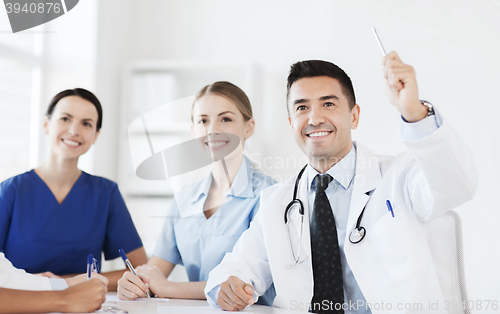 Image of group of happy doctors on conference at hospital