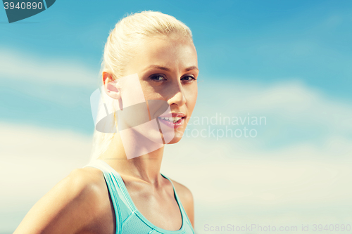 Image of happy young sporty woman outside