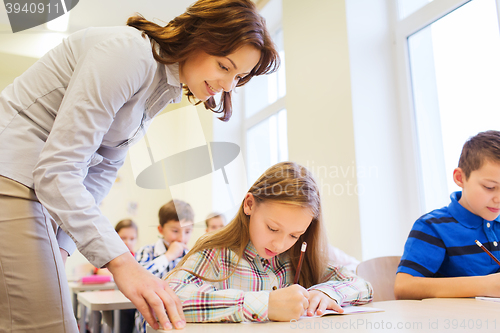 Image of group of school kids writing test in classroom