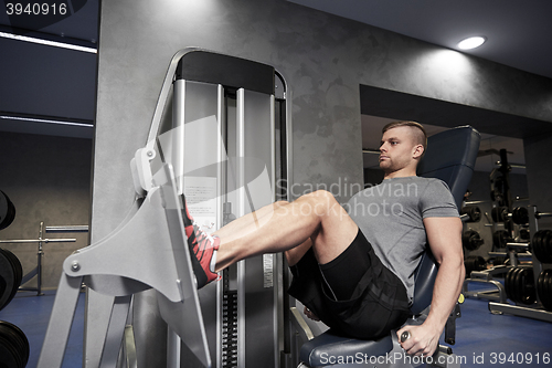 Image of man flexing leg muscles on gym machine