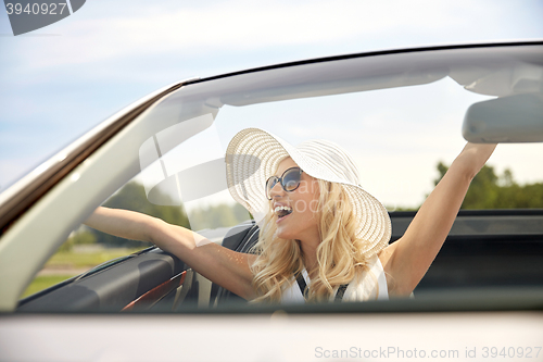 Image of happy man and woman driving in cabriolet car