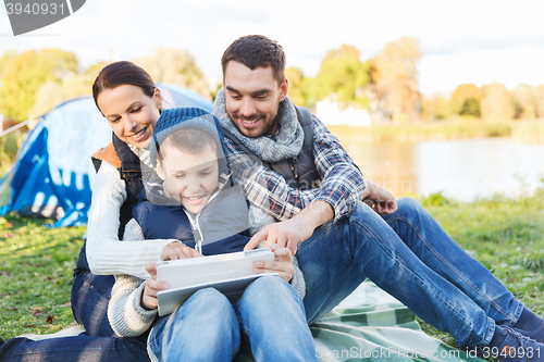 Image of happy family with tablet pc and tent at camp site