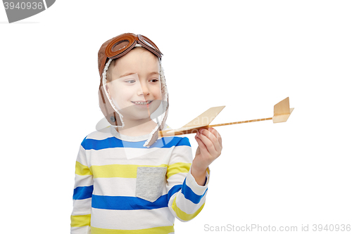 Image of happy little boy in aviator hat with airplane