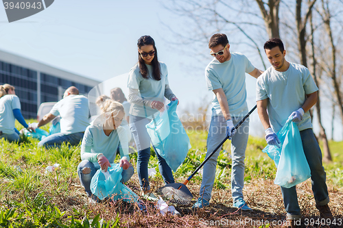 Image of volunteers with garbage bags cleaning park area