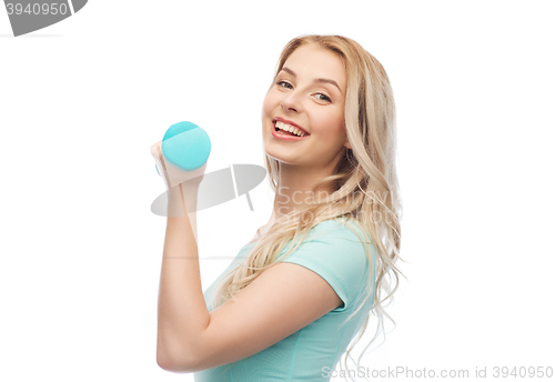 Image of smiling beautiful young sporty woman with dumbbell