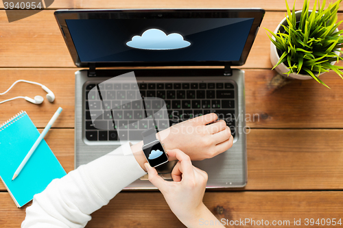 Image of close up of woman with smart watch and laptop