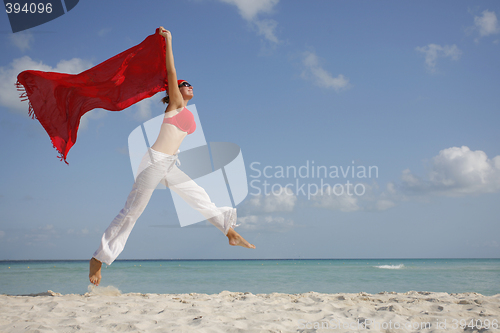 Image of Woman jumping on the Beach