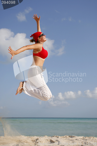 Image of Woman jumping on the Beach