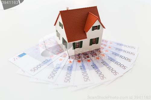 Image of close up of home or house model and money