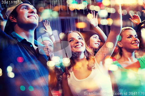 Image of group of happy friends at concert in night club