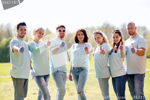 Image of group of volunteers showing thumbs up in park