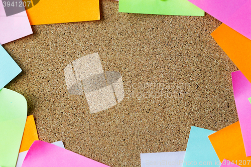 Image of close up of blank paper stickers on cork board