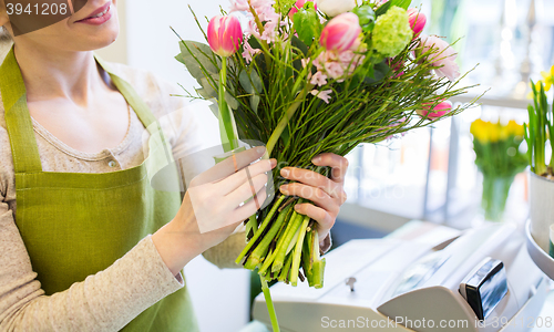 Image of close up of woman making bunch at flower shop