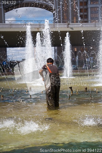 Image of Men clean of fountain pool.