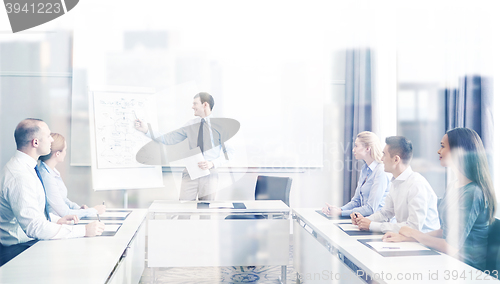 Image of group of smiling businesspeople meeting in office