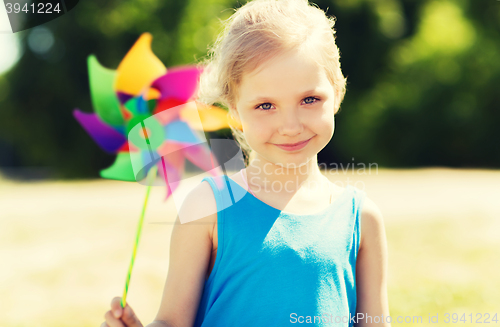 Image of happy little girl with colorful pinwheel at summer