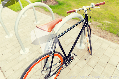 Image of close up of fixed gear bicycle at street parking
