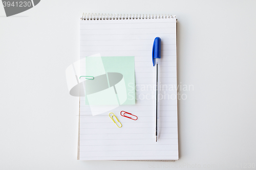 Image of close up of notebook with pen and bank paper