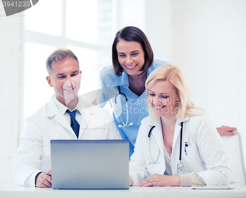 Image of group of doctors looking at tablet pc