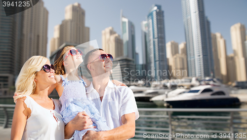 Image of happy family over dubai city street background