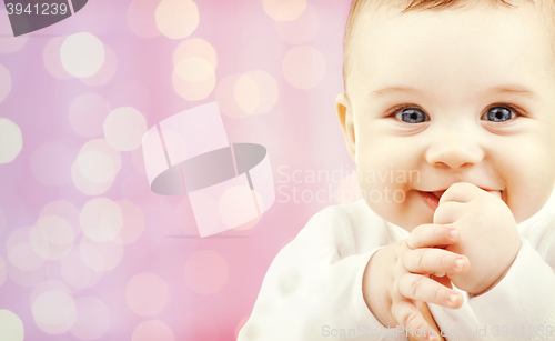 Image of happy baby over pink lights background