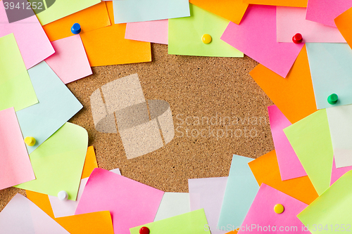 Image of close up of blank paper stickers on cork board